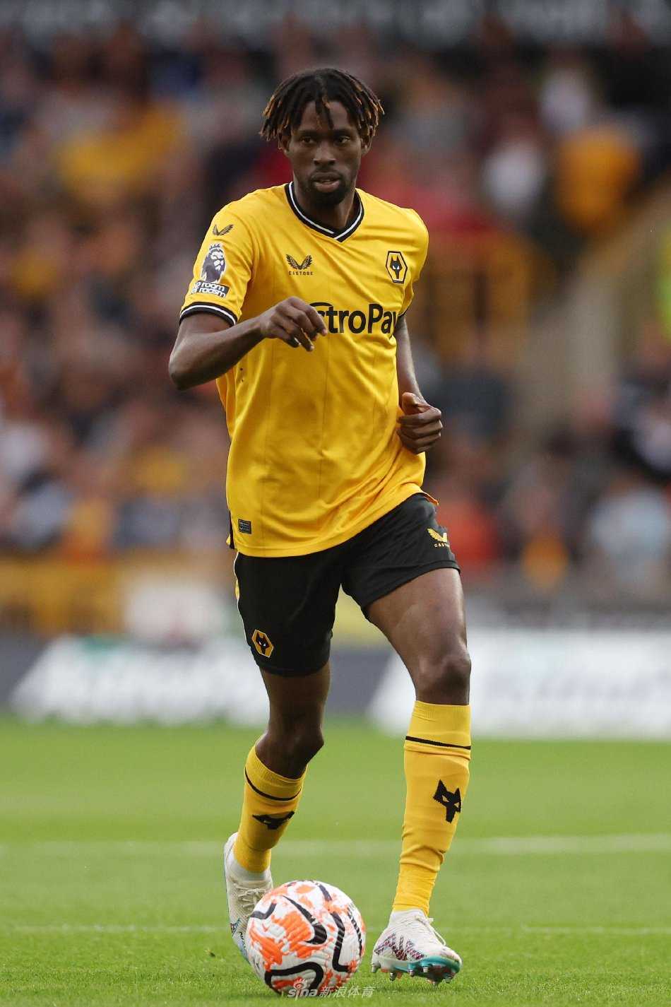 双方球员中场争顶：两名球员在灯光如昼的球场上同时跃起，时间仿佛静止，他们如角力的勇士，只为争夺那颗决定攻防方向的皮球，身影在夜空下拉出坚定的轮廓。