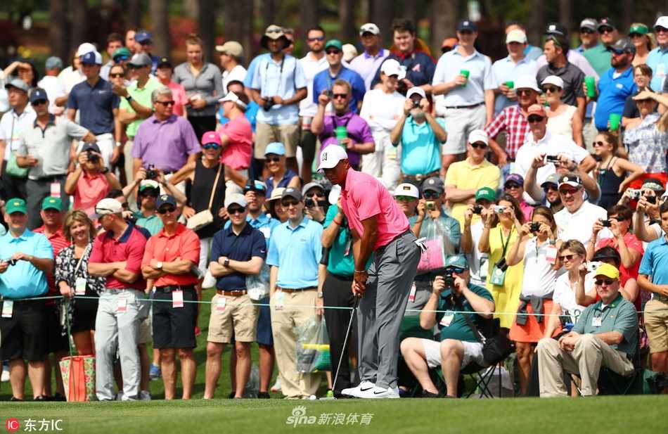 伍兹向远处眺望，奥古斯塔的标志性球道在他眼前铺开，眼神中充满对比赛的深思与期待。