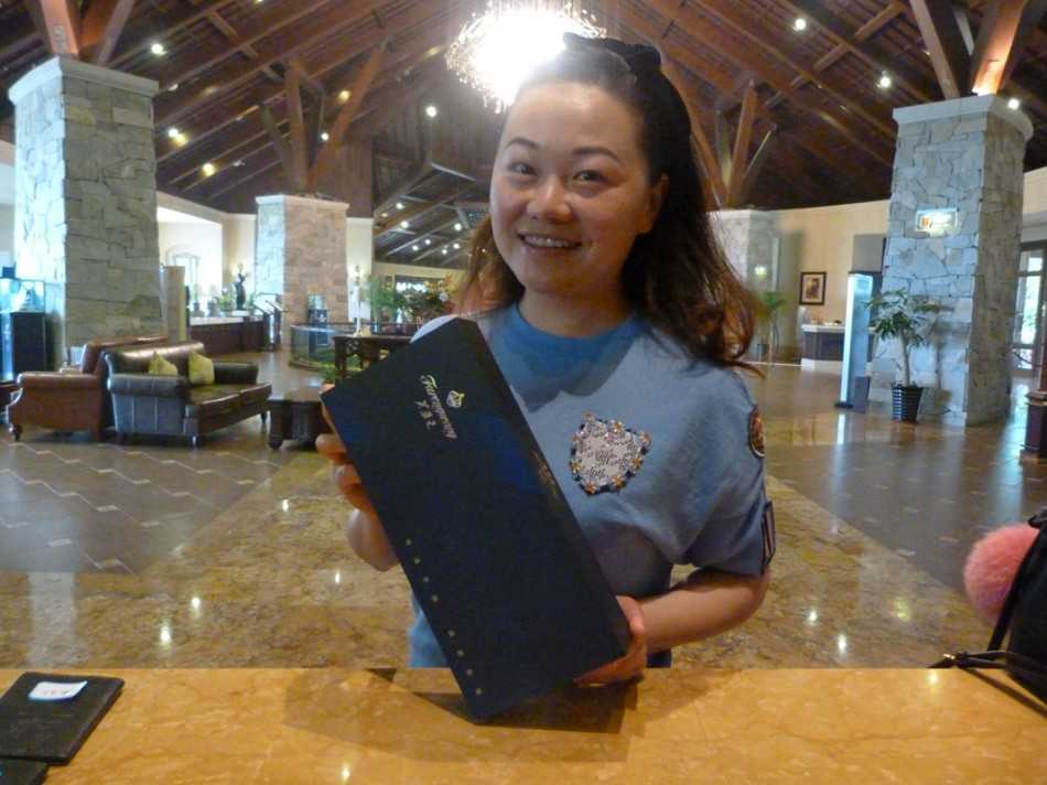 阳光下的高尔夫球道，背景中可清晰看到活动宣传展板，营造出浓厚的赛事氛围