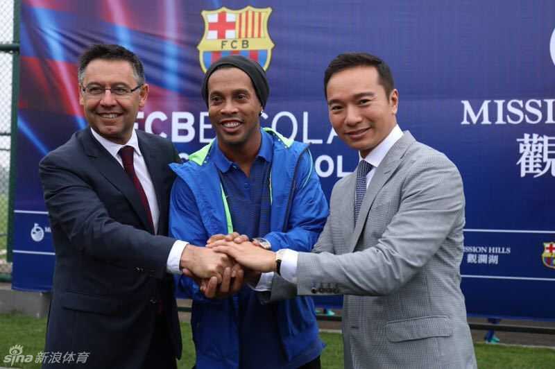 罗纳尔迪尼奥弯下腰，满脸慈爱地与一名紧张又兴奋的小球员紧紧握手，传递着鼓励与期许。