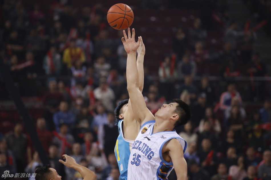 京城寒夜里的内线角力:北京首钢大胜福建,王哲林与莫里斯篮下争锋 莫里斯跳投瞬间,王哲林奋力扑防,两人在空中形成鲜明对抗,仿佛在夹缝中寻找投篮空间。