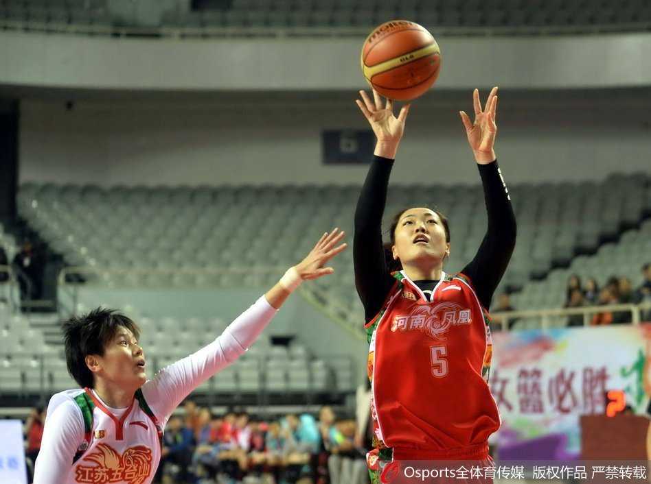 河南队孙杰在加时赛中命中关键跳投后握拳怒吼，身旁的江苏队陈晓佳面露无奈，背景是分秒必争的计时器。