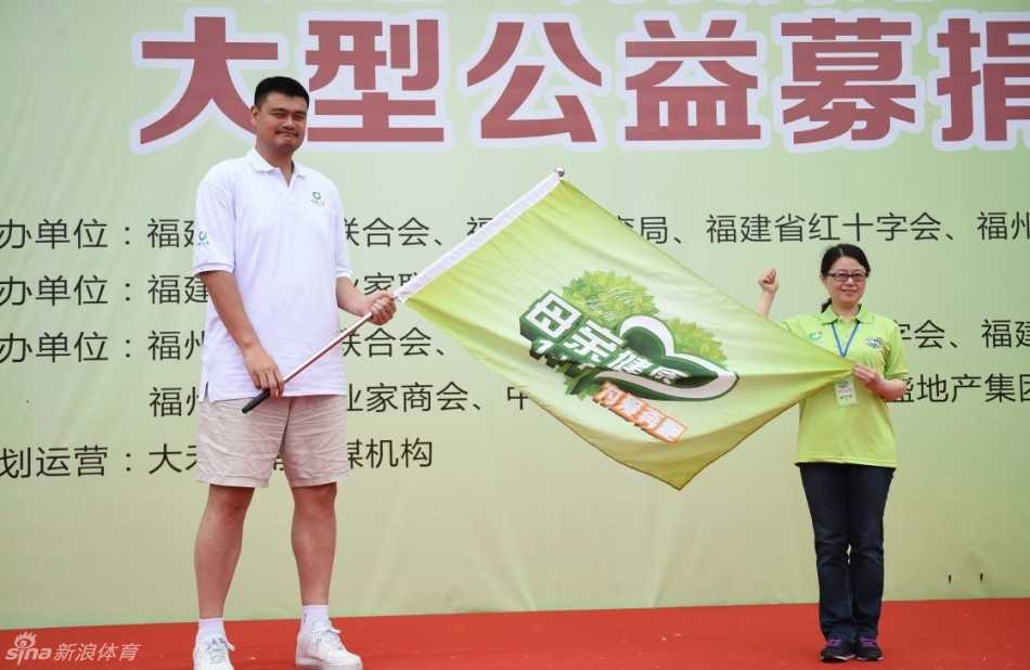 在人山人海的活动现场，姚明像一座高大的灯塔，他面带微笑，亲切地俯身与身边的孩子们击掌互动，周围是无数双充满好奇与兴奋的眼睛。