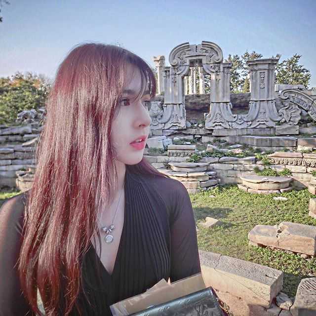 这张抓拍定格了阿迪娜的纯真瞬间，她身穿白色外套，五官精致立体，笑起来眼睛弯成月牙，既有少女的羞涩又有新疆姑娘特有的灵动秀美。