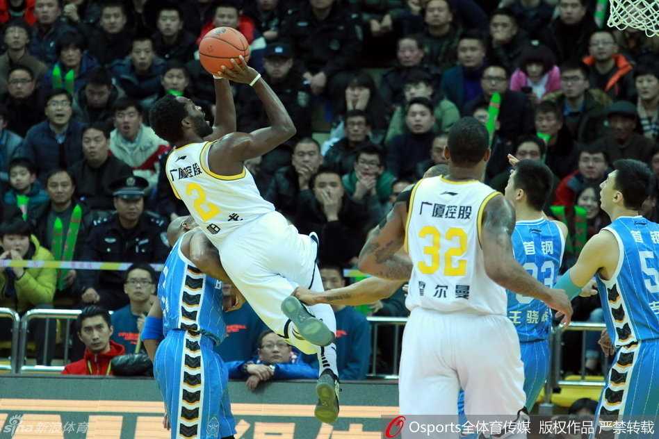 北京队球员翟晓川在拼抢中倒地，他双手撑地，眼神中充满了不甘和对胜利的渴望，身旁是同样在激烈对抗的吉喆。