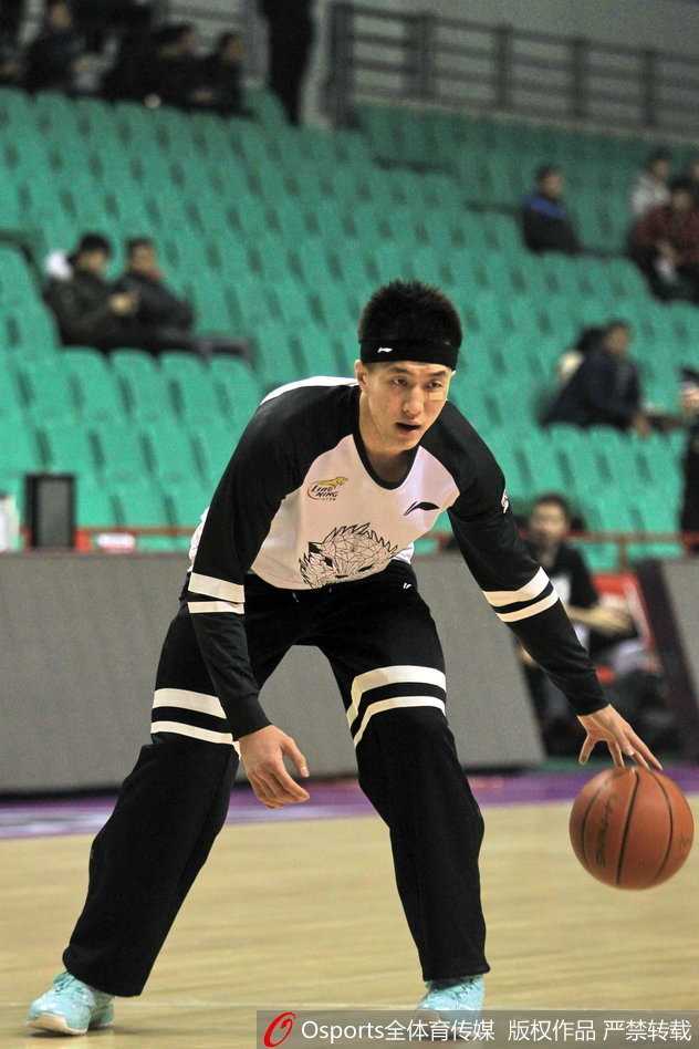 近距离特写，可以清晰地看到郭艾伦脸上的创可贴和专注的面部表情，背景虚化效果突出了这位球场硬汉的形象。