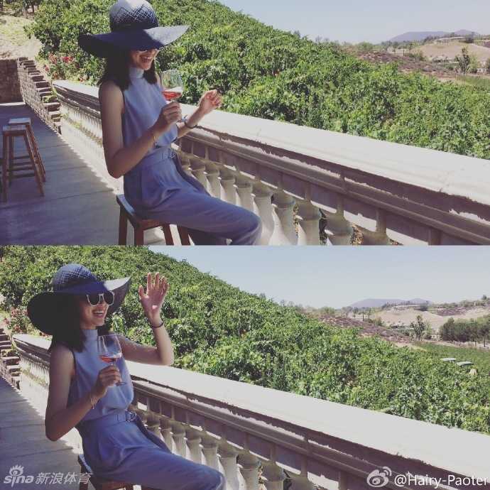 李跑与一位女性友人亲密相依，两人对着镜头露出开心笑容，背景是美式风格的街道，画面充满了闺蜜间轻松愉快的交谈氛围。