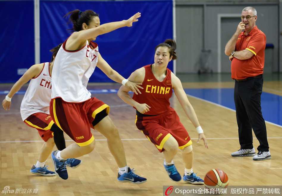 队员们迅速围绕在主帅马赫身边，孙梦然、邵婷等主力队员俯身倾听，马赫则弯着腰用手势比划着刚刚训练中出现的问题，要求大家立即改进。