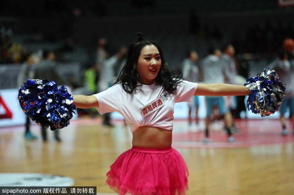 一位篮球宝贝正在赛场中央尽情热舞，她张开双臂，身姿舒展，仿佛一只翩翩起舞的蝴蝶，全情投入地享受着这个属于她的舞台。