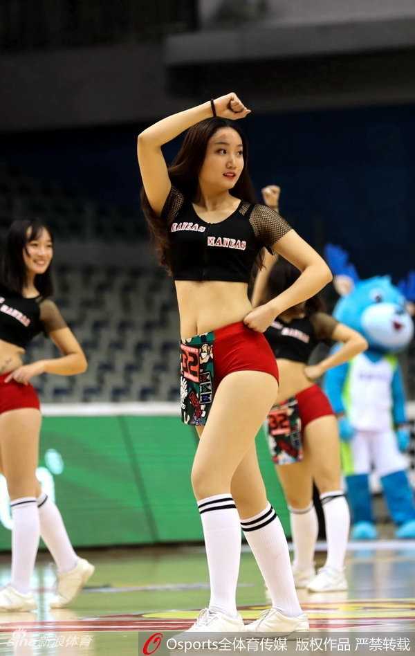 新疆女篮啦啦队宝贝们扎着利落的高马尾，身着红白相间的活力队服，在球场中央排开整齐队形，随着动感音乐跃起，修长的身姿在空中定格，瞬间点燃全场热情。