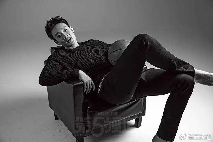 丁彦雨航站在空旷的场馆内，身穿深色运动上衣，双手插兜姿态放松，但眉宇间依然保持着运动员特有的英气，尽显成熟魅力。