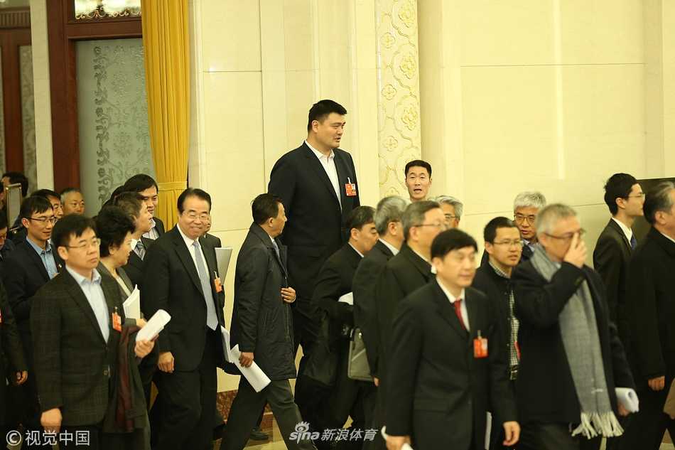 会议结束后，姚明与王励勤在大会堂外偶遇老朋友，几人停下脚步握手寒暄，姚明脸上露出标志性的憨厚笑容，王励勤则在一旁静静聆听，画面充满了老友重逢的温情与履职尽责的庄重。