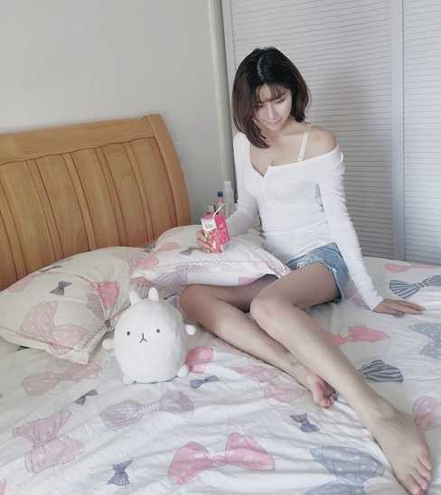 夕阳的余晖洒满海面，一位空姐侧身坐在礁石上，目光悠远地望向远方。剪影勾勒出她完美的身形曲线，画面静谧而美好，仿佛一幅现代油画。