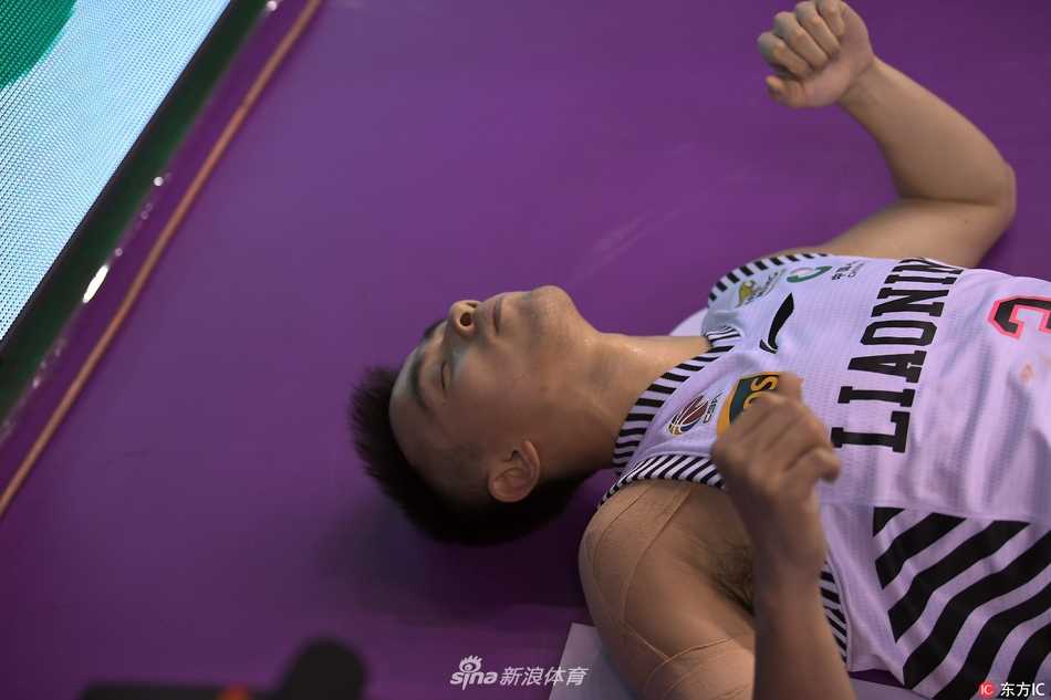 队友们围绕在赵继伟身边，有的蹲下询问伤情，有的神情焦虑地望向场边，等待担架的到来。