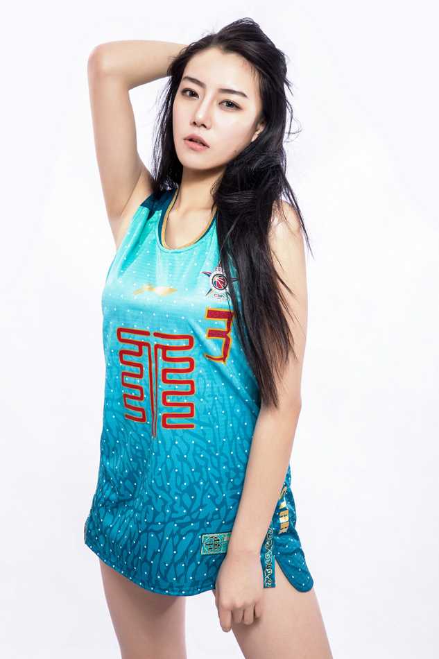 一位气质出众的女神回眸一笑，身后的五棵松体育馆灯光璀璨，她的眼神中充满了对这场篮球盛宴的期待。