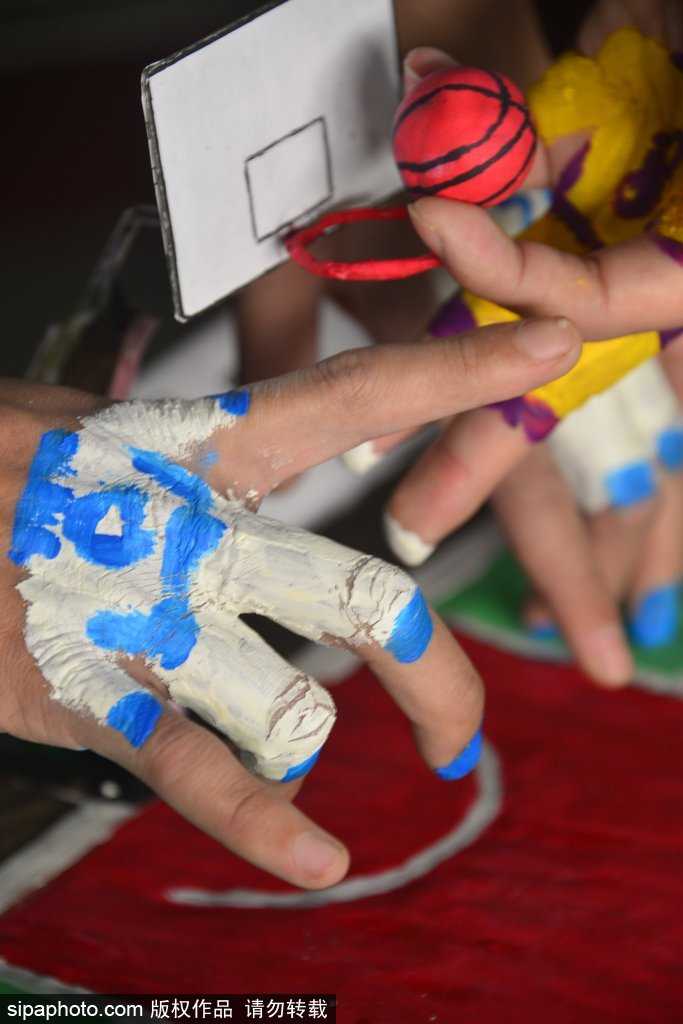 方寸指尖演绎篮球激情 聊城大学萌趣指尖比赛乐翻冬日校园 一位学生正全神贯注地盯着指尖下的‘篮球赛场’,他微微弯下腰,用涂了颜色的手指灵活地‘运球’突破,脸上的表情既认真又带着忍俊不禁的笑意,仿佛正在进行一场真正的NBA总决赛。