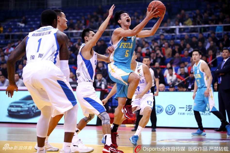 青岛队主帅在场边神色严峻地指挥作战，面对场上不断被拉大的分差，他双手比划着战术手势，试图力挽狂澜，但无奈球队防线已千疮百孔。