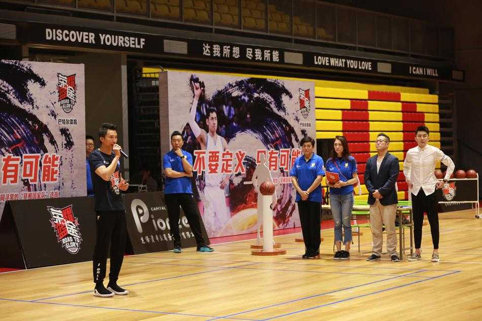 晋级十四强的队伍围成一个圈，手臂搭着彼此的肩膀，齐声怒吼庆祝，汗水在灯光下闪闪发光，背景是渐渐落下的夕阳和仍在收拾器材的工作人员。