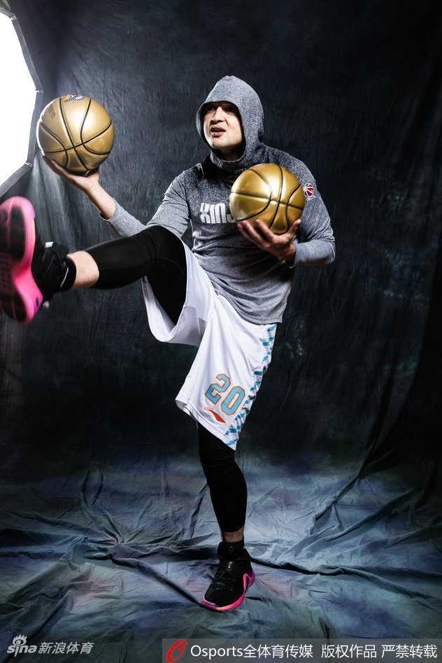 西热力江在昏暗巷道中侧身回眸，链条装饰和运动裤的搭配凸显运动潮流感，眼神依旧犀利充满杀气