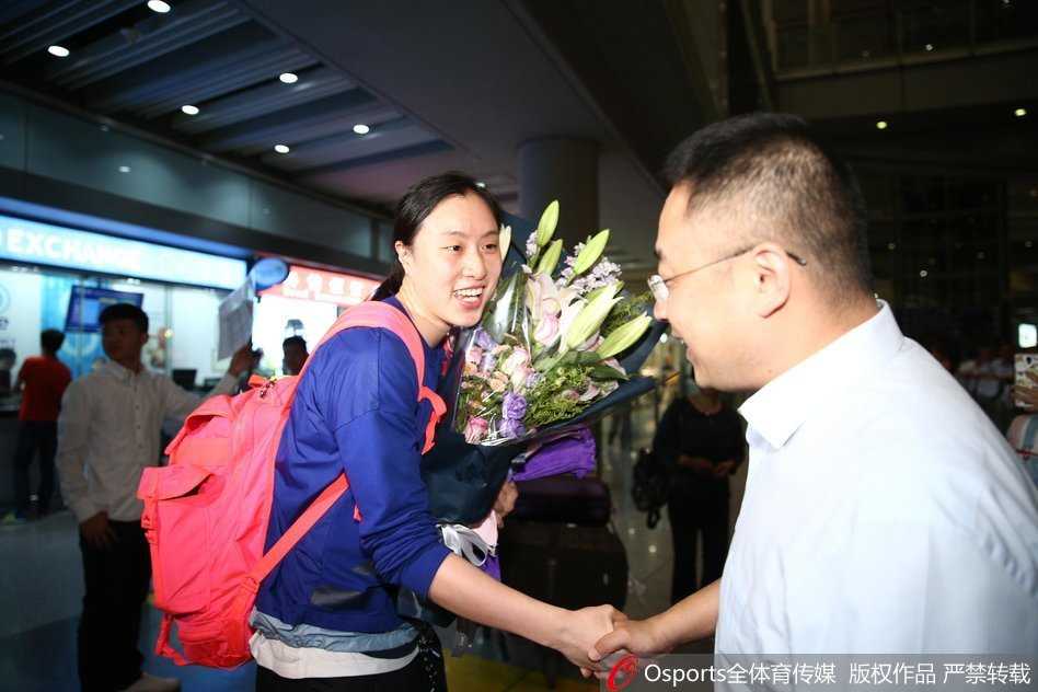 球迷为邵婷送上精心准备的鲜花，她低头轻嗅花香，满脸幸福