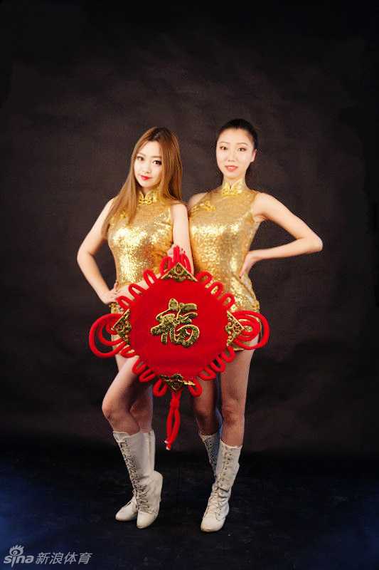 写真中的宝贝身穿改良款中式旗袍裙，裙摆随着她轻轻扭动的身姿微微飘起，手举红灯笼，眼神中流露出娇俏与灵动