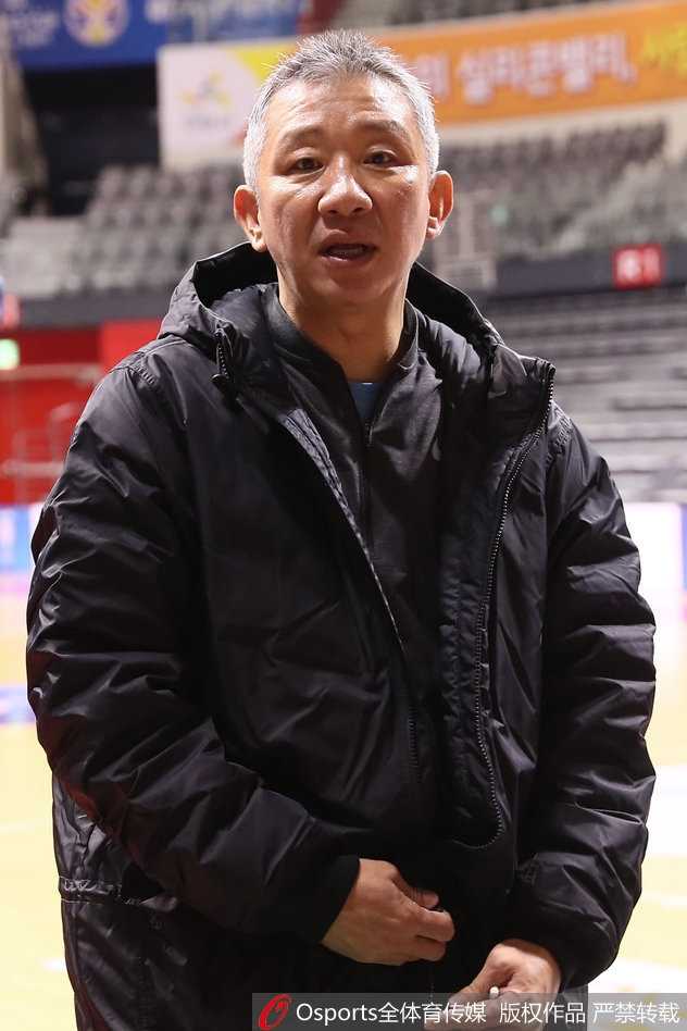 韩国男篮厉兵秣马剑指武汉,归化神塔罗健儿领衔欲破世界大赛坚冰 训练间隙,两名球员坐在场边休息,其中一人抱着篮球露出标志性的憨厚笑容,眼神中满是对即将到来的世界杯正赛的憧憬与期待。